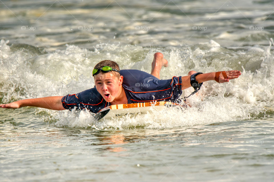 Boy body surfing