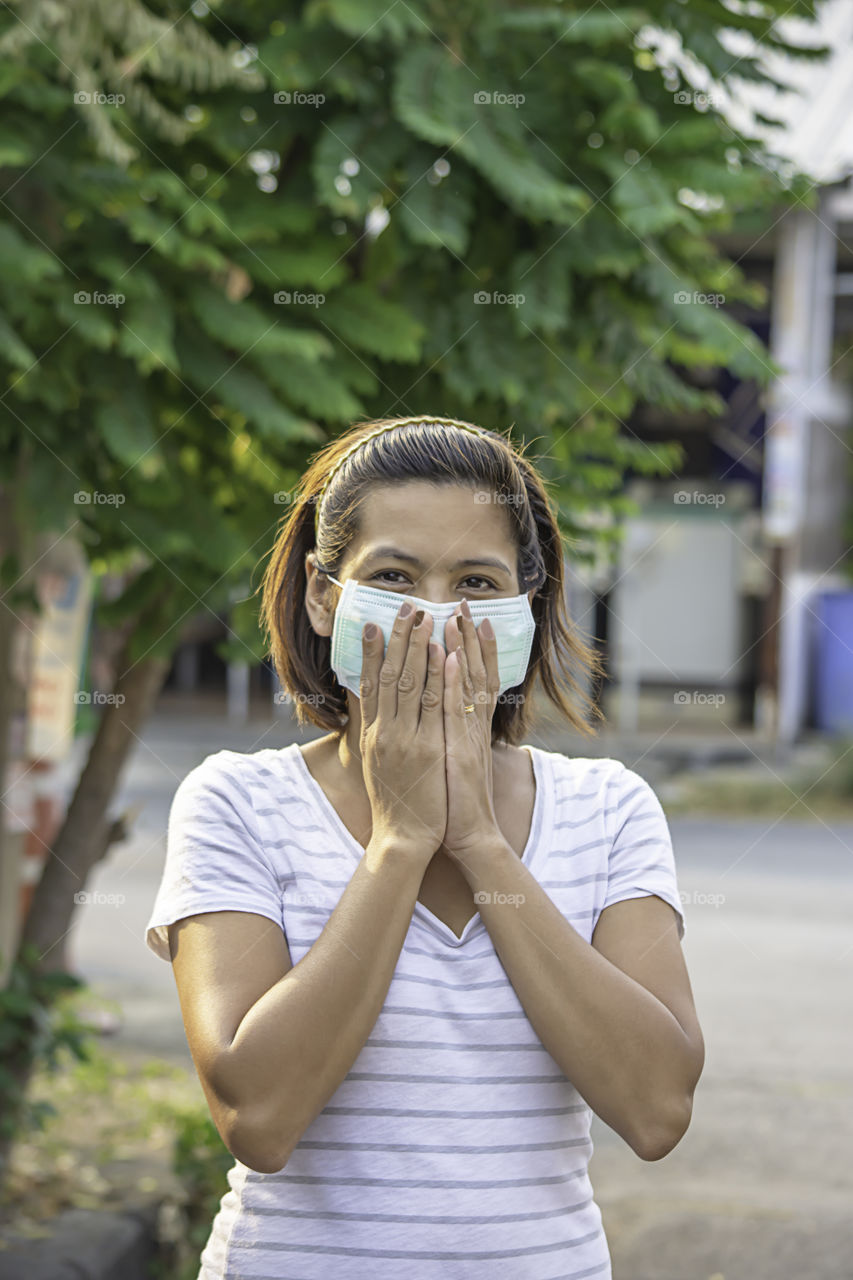 Asean Woman wear a mask to prevent dust in Bangkok ,Thailand.