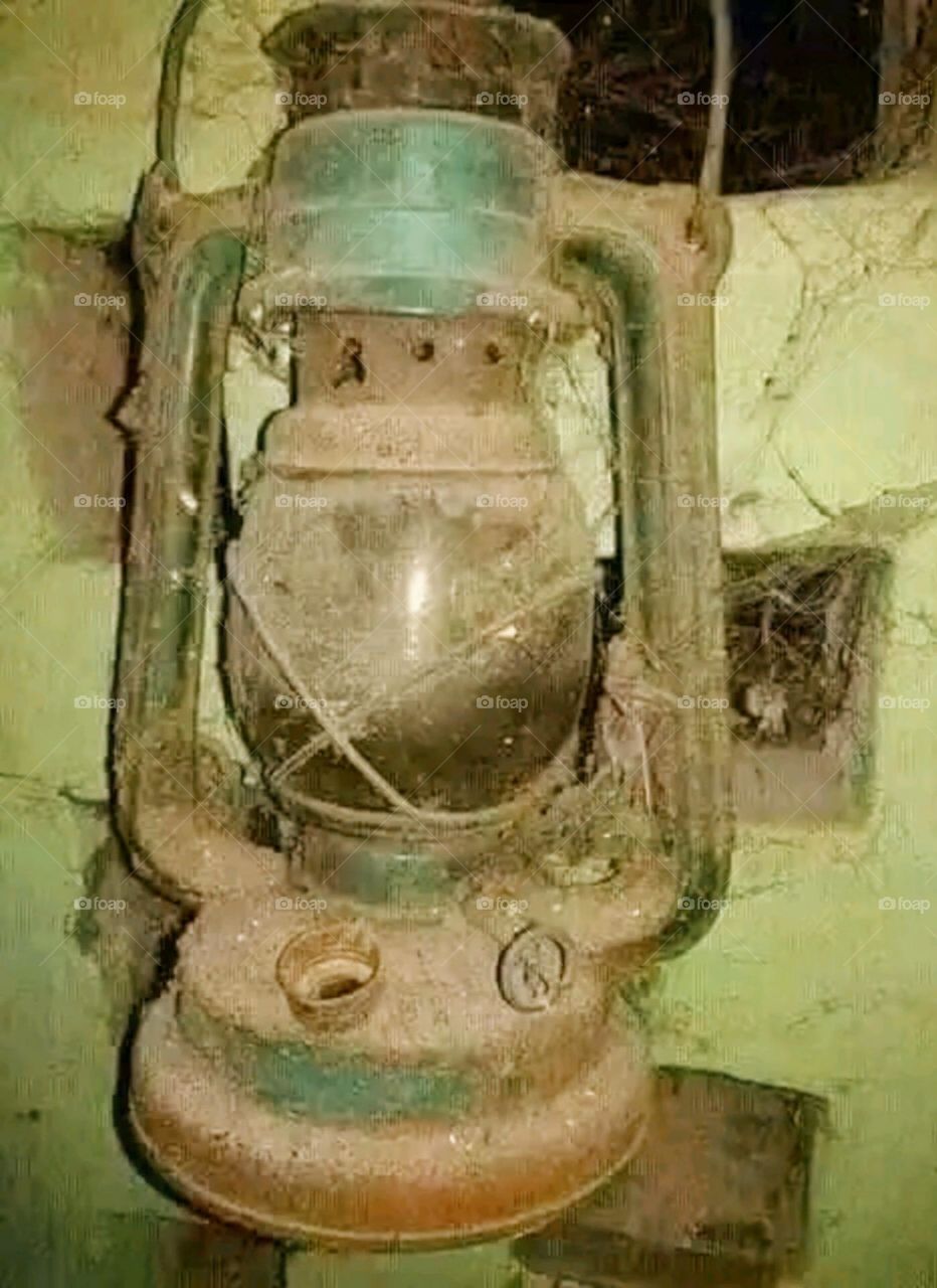 A lantern in a very old and dilapidated condition.