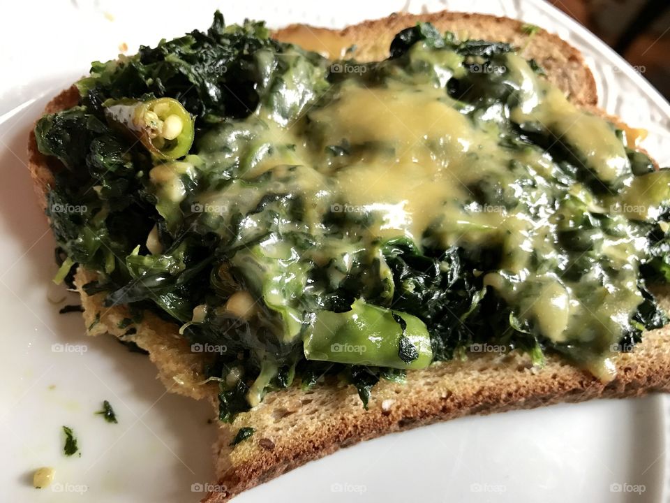 Spinach melted cheese over toast 