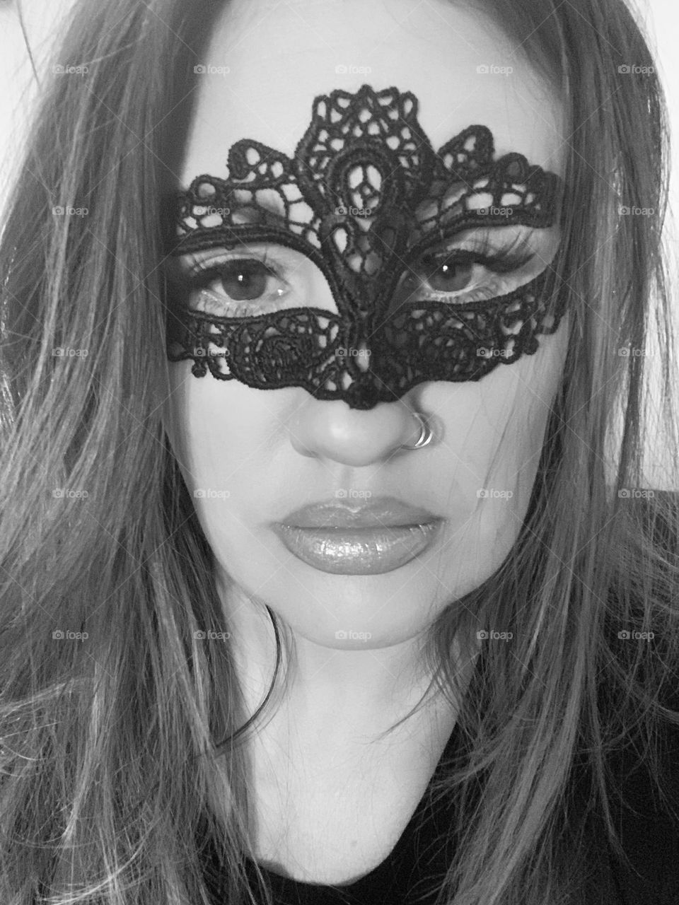 Black and White picture of a woman wearing a mask at a party! 