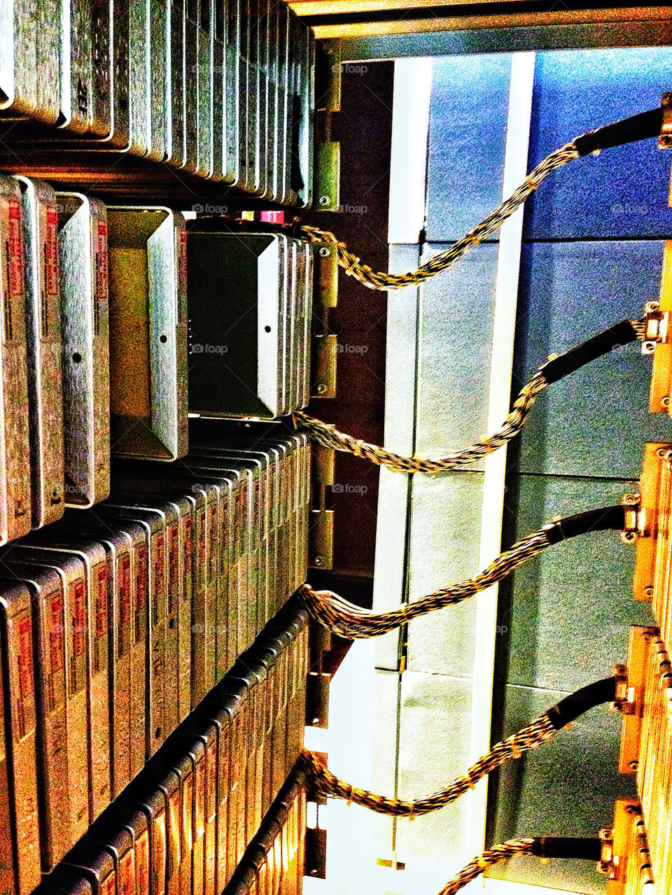 Stack of retro computer hard drives in a server cabinet rack with