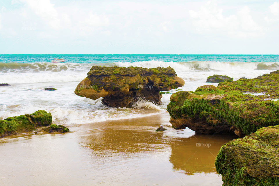 Beach with boat and coral reefs