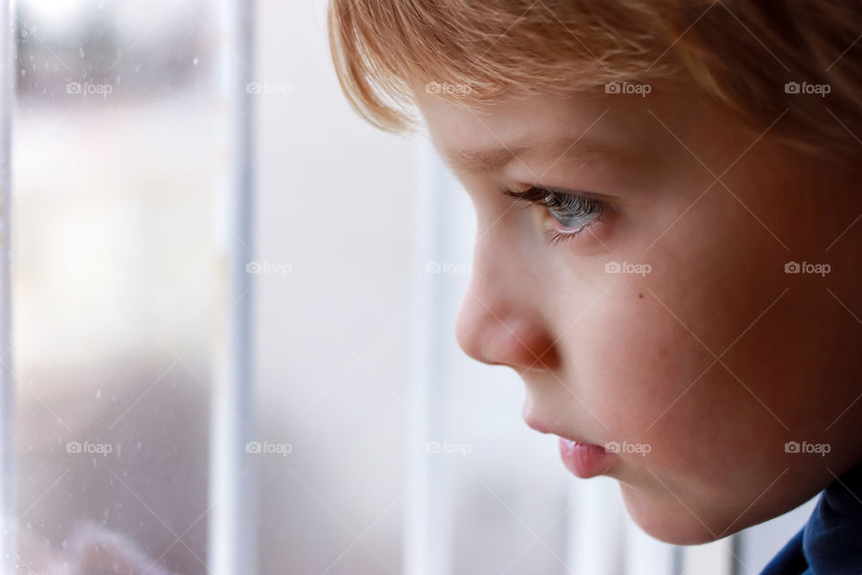 A child's looking through the window