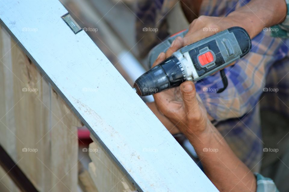 Close-up of hand holding drilling machine