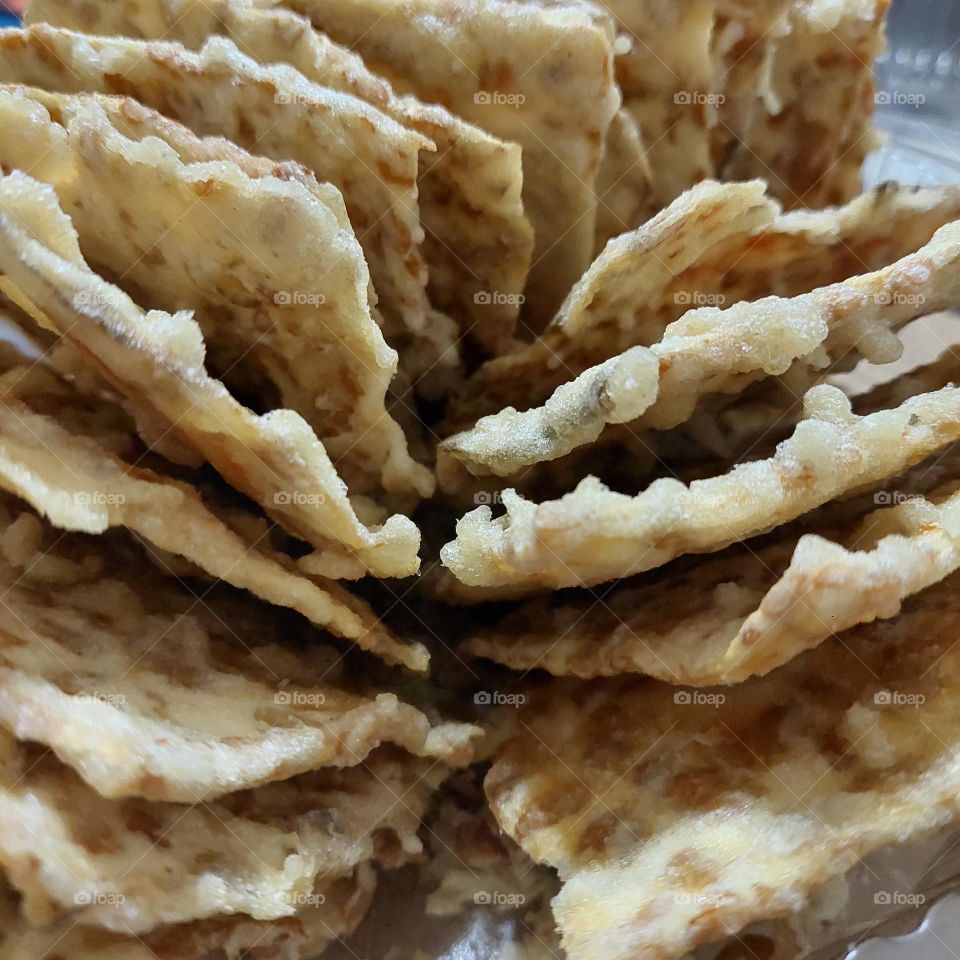 Fried tempeh is a delicious and healthy snack.  Soybean is the basic ingredient to make it