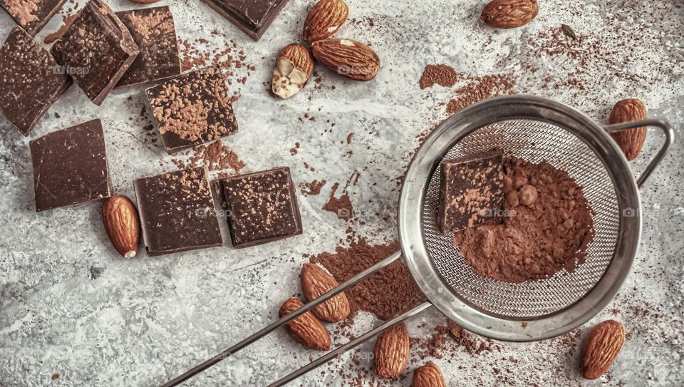 chocolate, cocoa and nuts on a light background