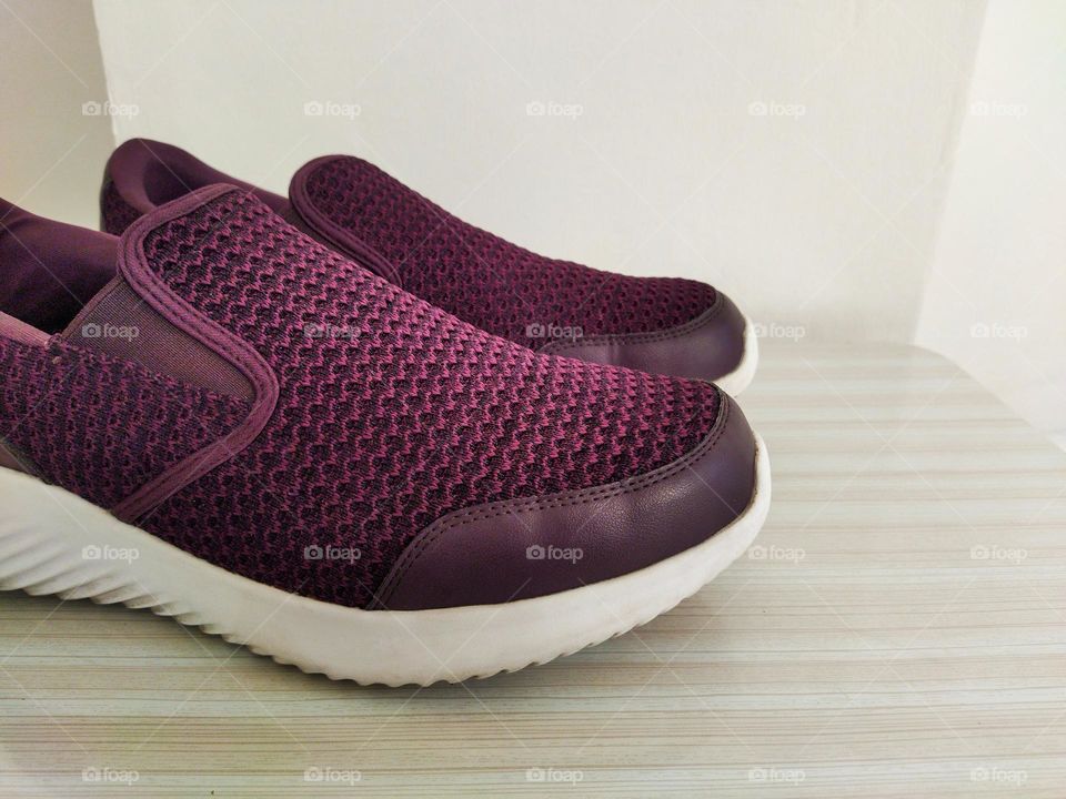 close-up of purple shoe with second shoe on the background