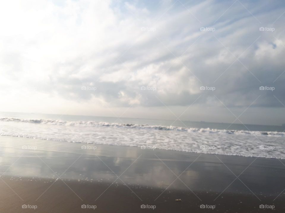 Stunning natural scenery with a wide beach and calm waves is perfect for surfing or a summer holiday