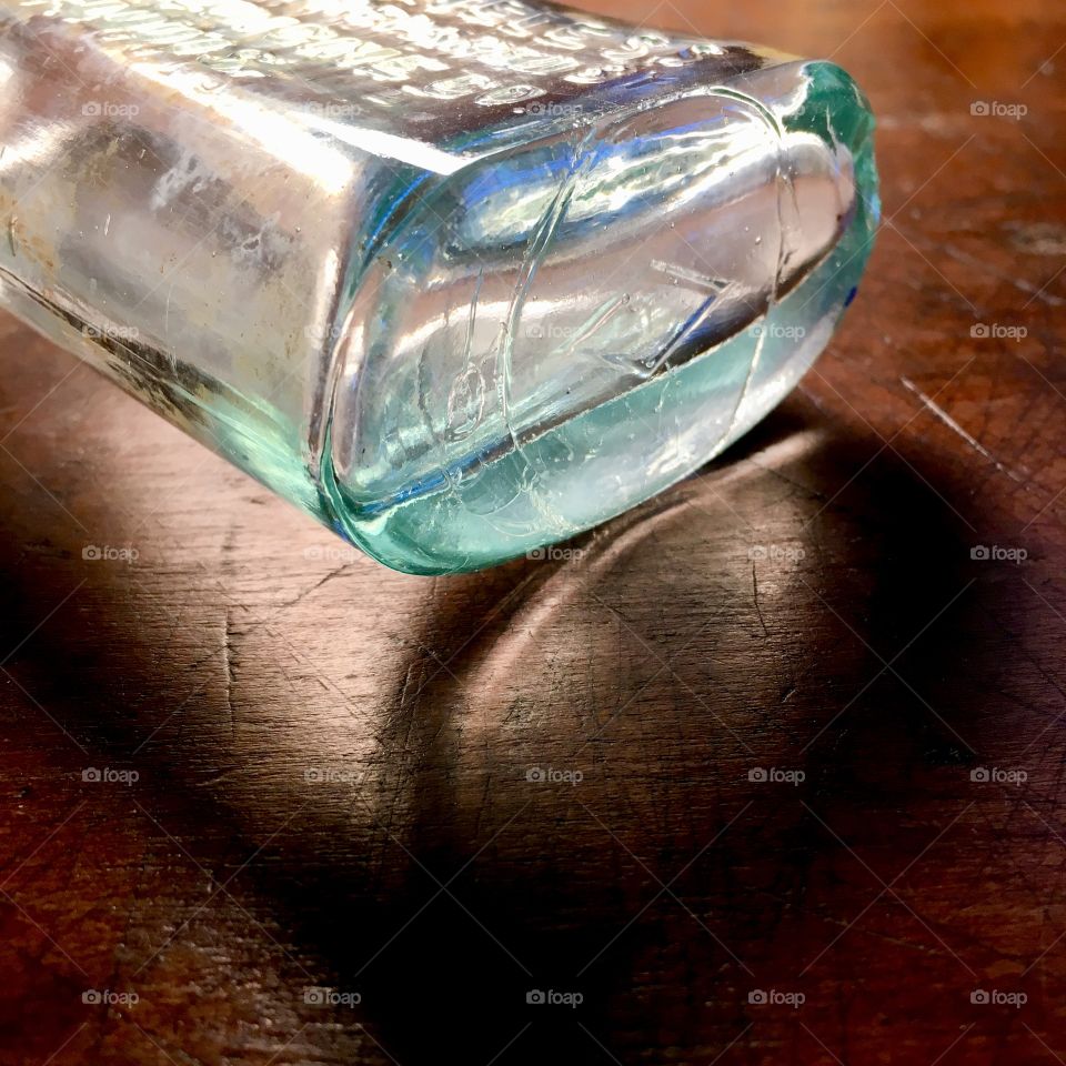 Light shining through empty bottle 