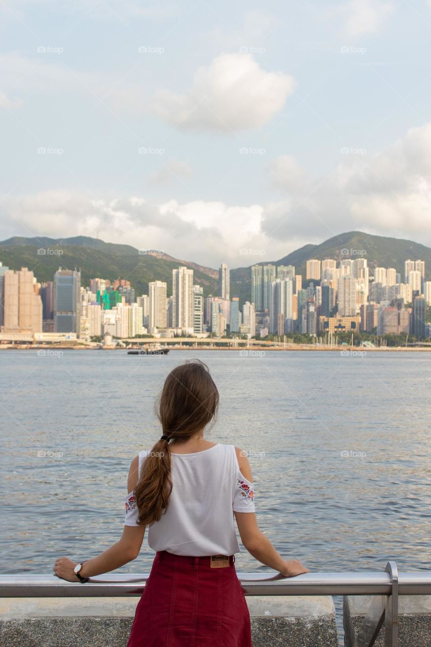 Young woman enjoying the view during the summer vacation in Hong Kong 