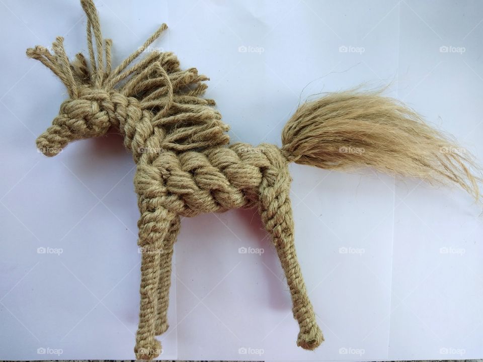 Rope knitting art ,rope horse isolated on white background.