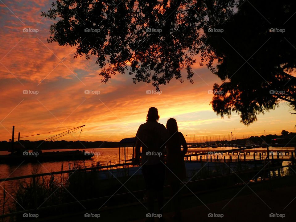 Silhouette of couple standing near the lake