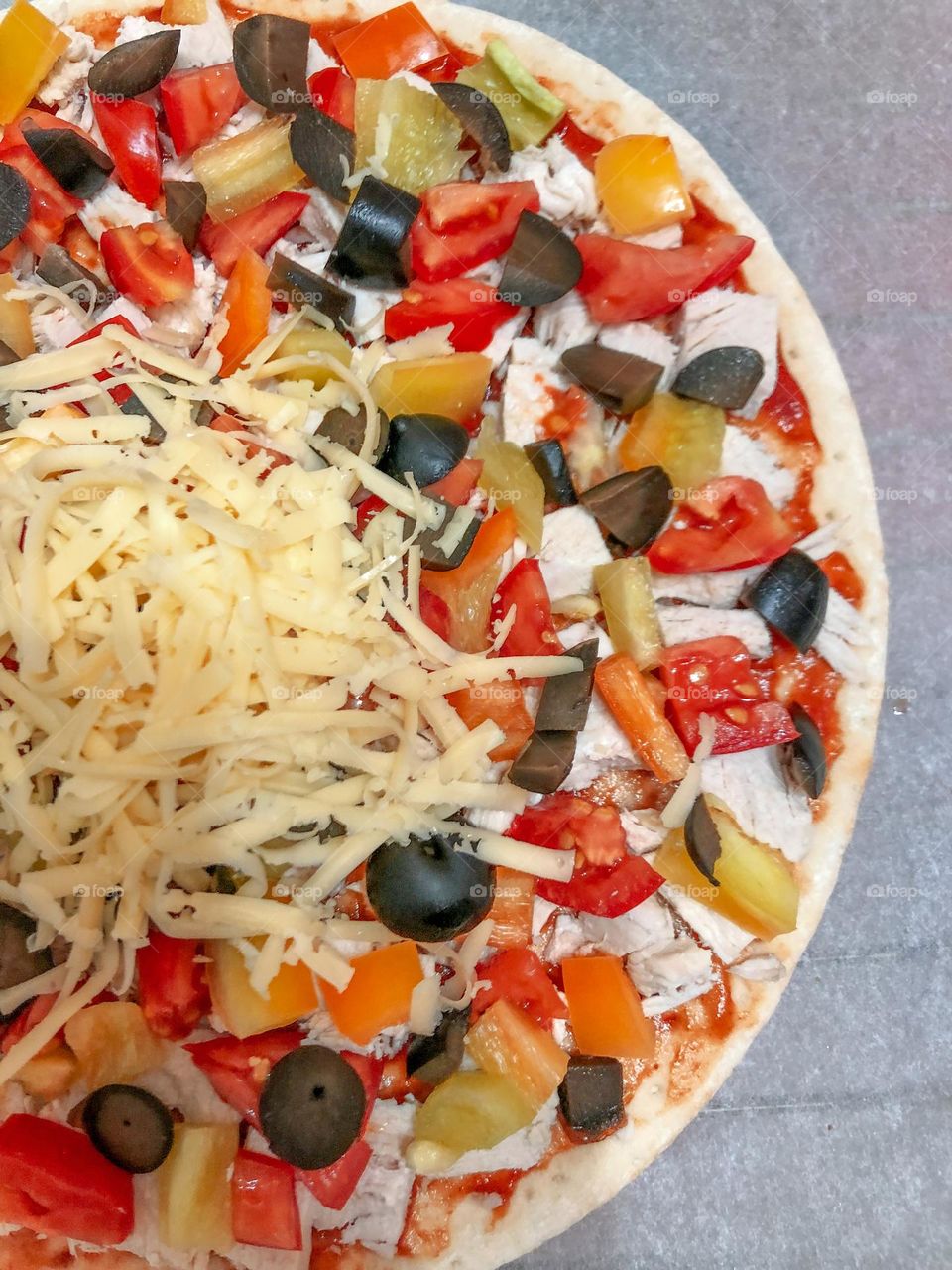 Cooking pizza with pepper and olives