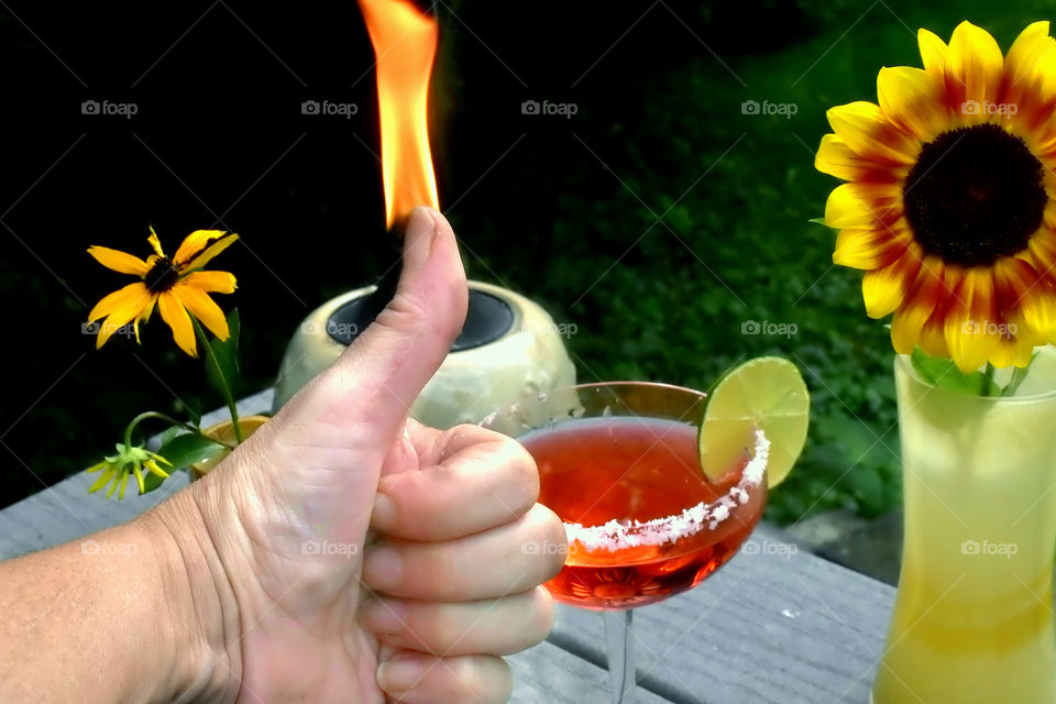 Thumbs up at the perfect drink, fire and flower