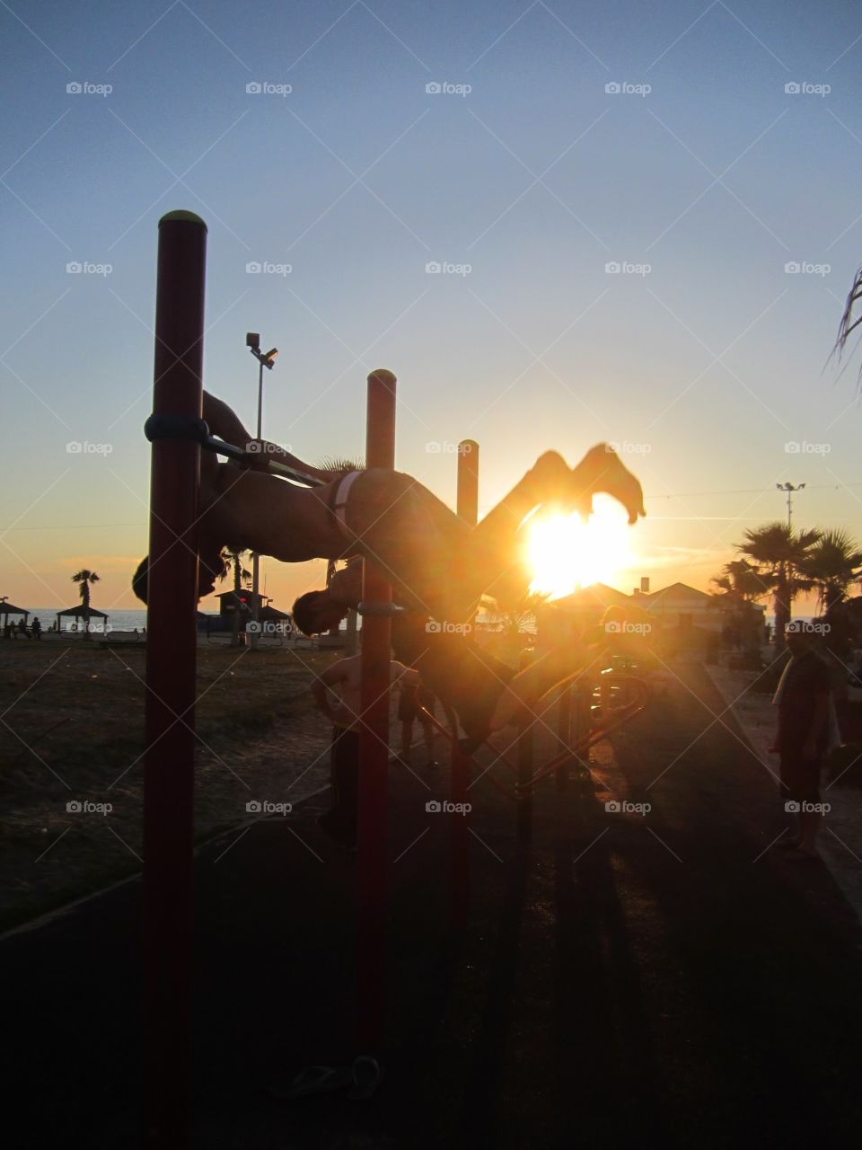 fitness on the beach. athletic group on horizontal bar