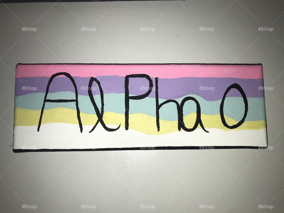 Alpha omicron pi lettered canvas with black letters on a pastel colored wavy background