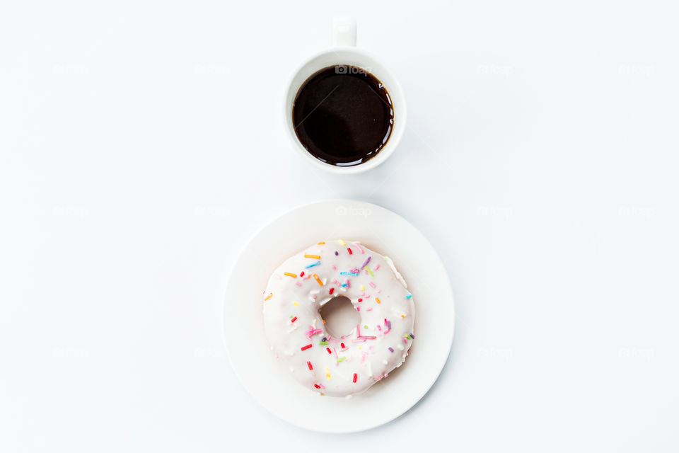 Flatlay of coffee cup and donut 