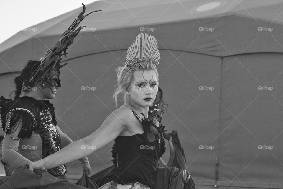 a girl with an interesting facial expression with a cold look in an interesting fancy dress and makeup.