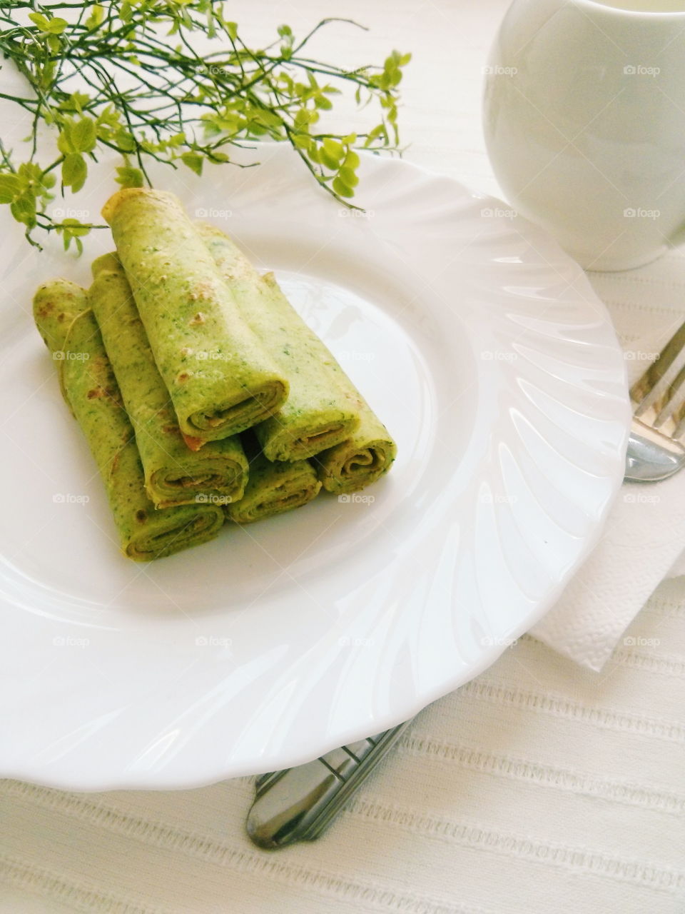 Green pancakes. Green pancakes on white plate