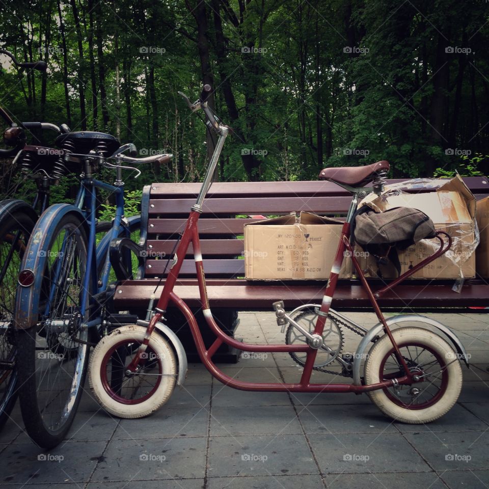 Two vintage bicycles standing near the fence