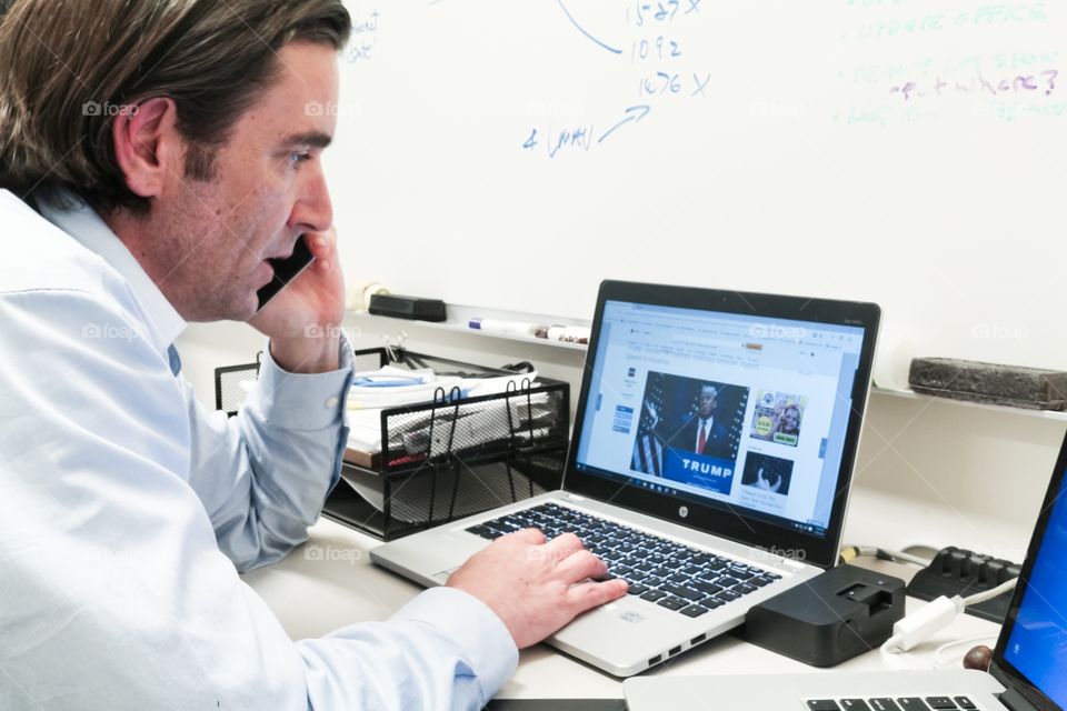 Working on a laptop and talking on my mobile device 