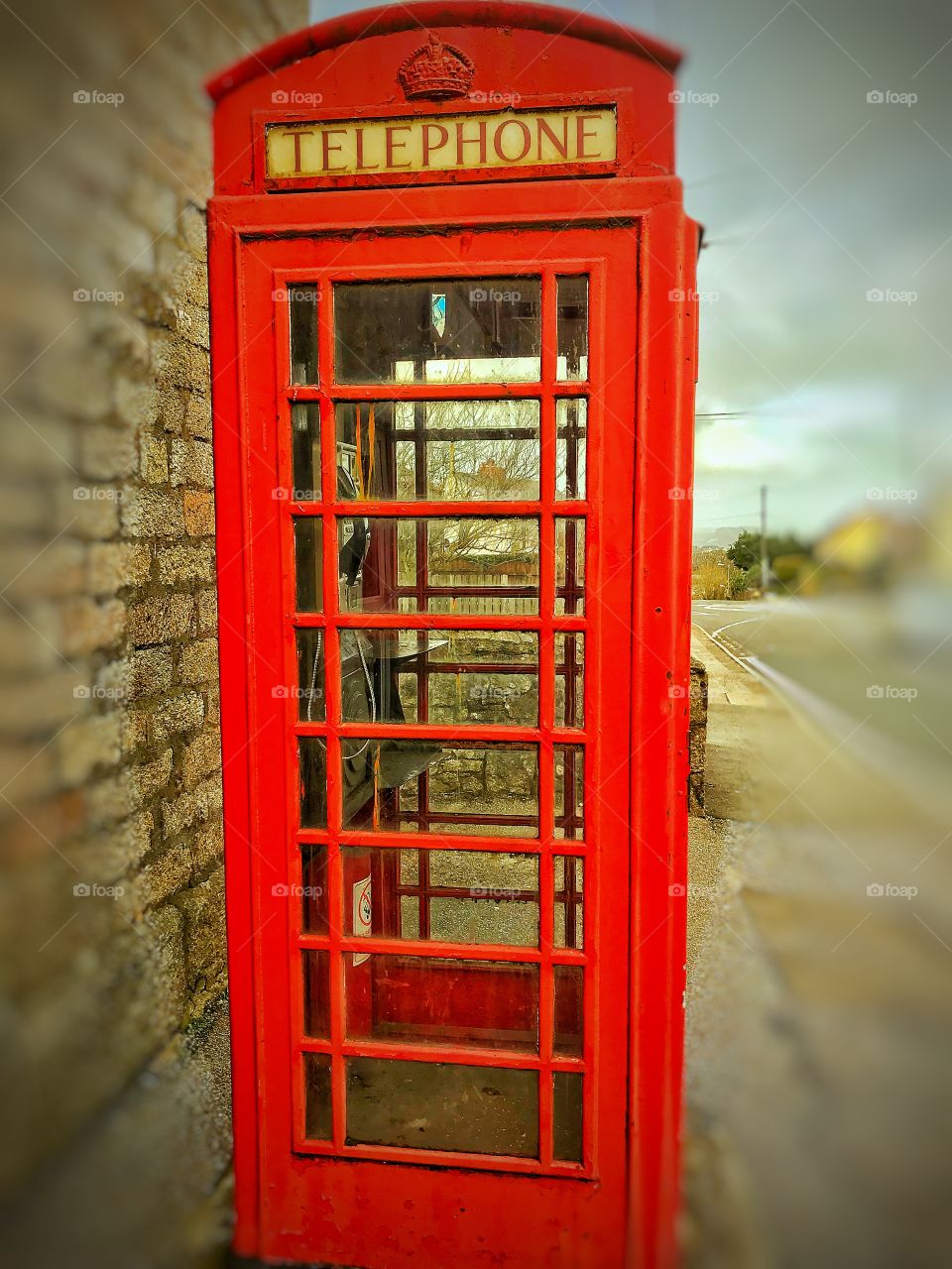 An old bright red telephone box