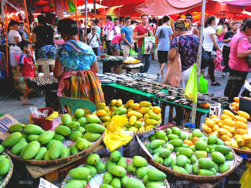 asian street vendor selling fruits and vegetables in quiapo, manila, philippines in asia