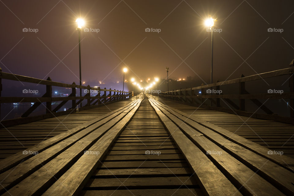 Wood bridge at night in Sagklaburi Kanchanaburi Thailand 