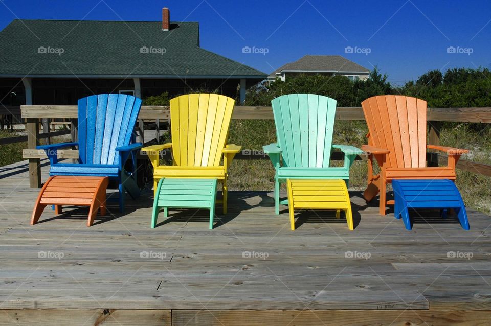 Colorful Adirondack chairs at a beach home. 