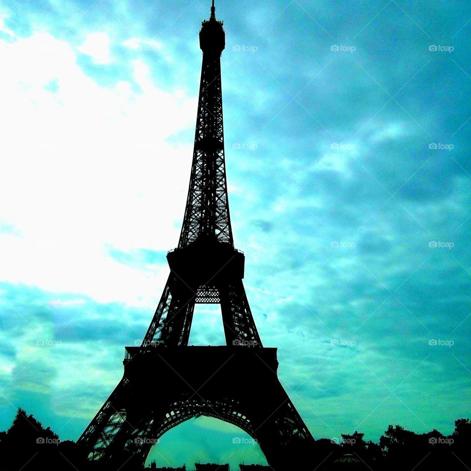Eiffel Tower in a blue cloudy sky