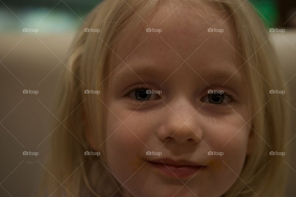 Portrait of a little blonde girl smiling 