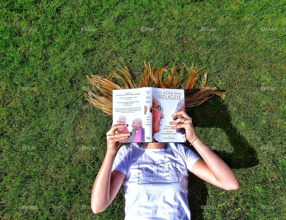 Reading a book in the grass