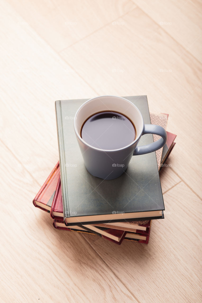 A few books with cup of coffee and cookies on wooden floor. Time for relax. Spending leisure time on reading. Cozy and comfortable. Learning from books 📖Studying for the next exam 😌