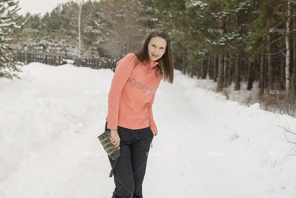 woman without a hat in the winter in the forest