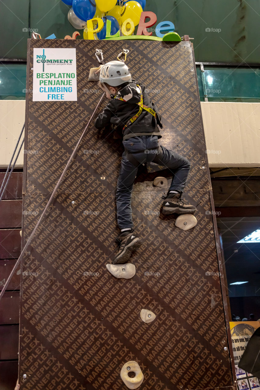 Boy climbing on the wall