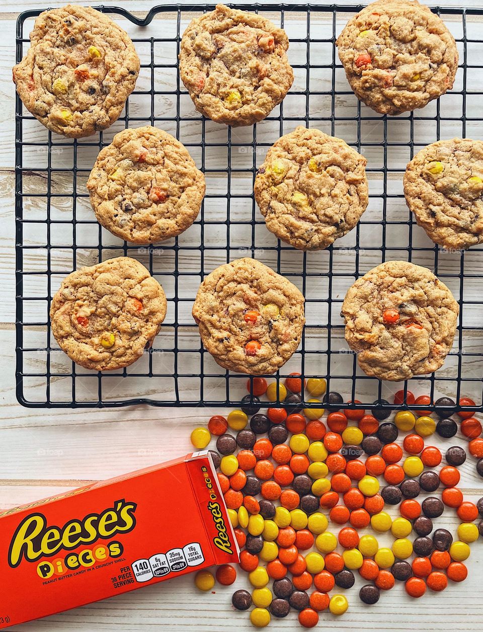Freshly baked Reese’s Pieces Chocolate Chip Cookies on a cooling rack, making delicious cookies at home, baking in the kitchen, smartphone food photography, cookies for toddlers, delicious treats made at home, homemade cookies in the kitchen