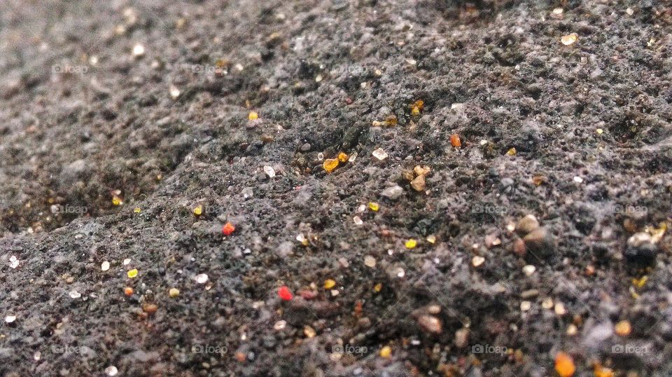 Black sand on Bali with plenty of crystal like grains that come in rainbow colors