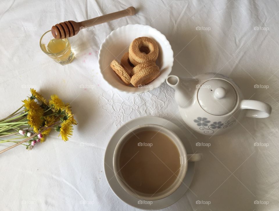 Cup of tea with honey and cookies