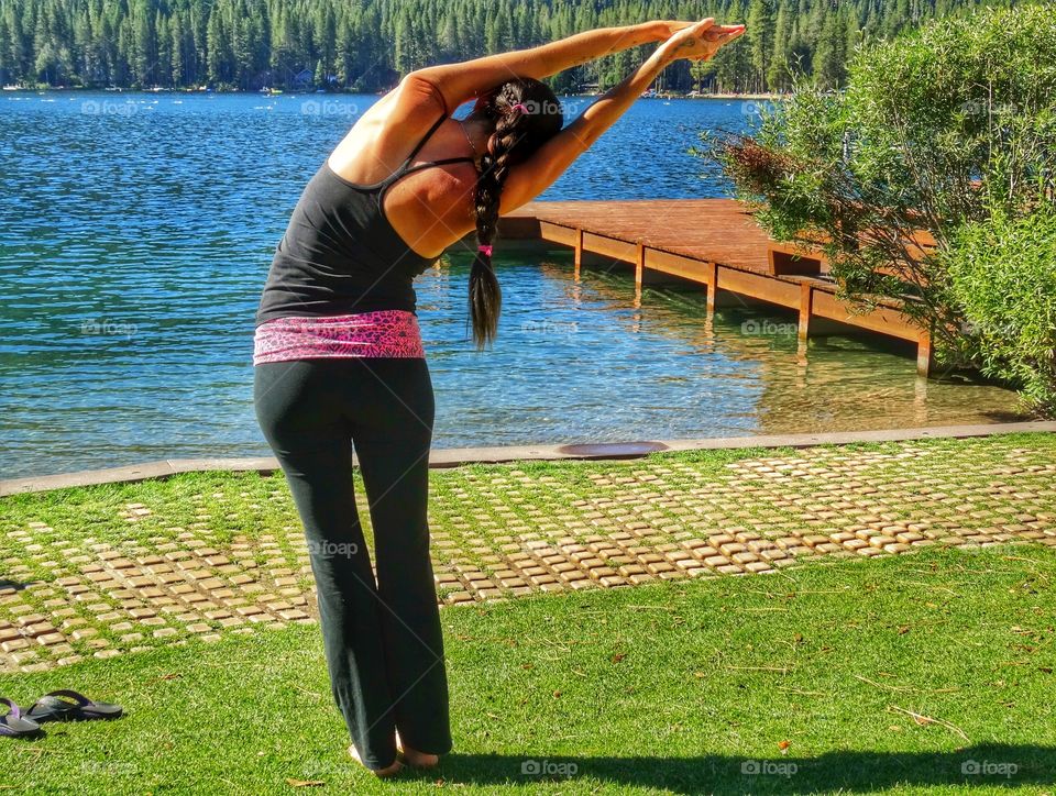 Woman Doing Yoga By A Lake