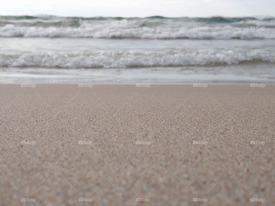 Unfiltered beautiful sand and waves on the beach