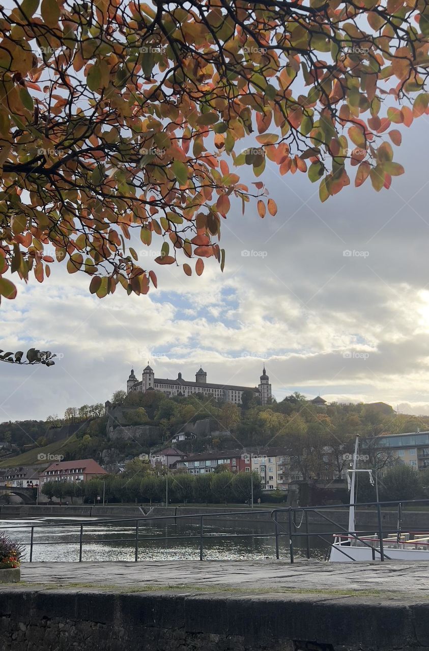 Landscape with autumn coloured leaves and fortress in the background.