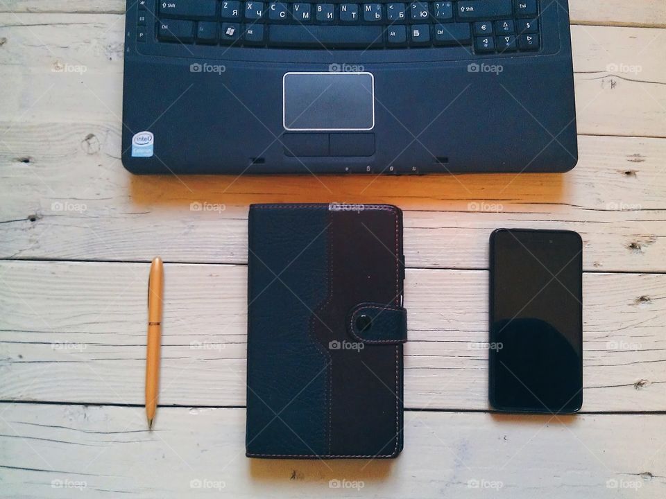 notebook, pen, organizer, a smartphone on the desktop