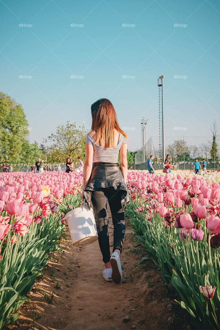 Girl walking through to the tulips