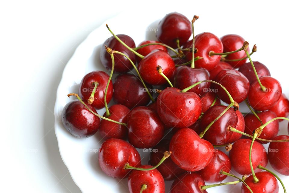 red cherry summer food on a plate white background