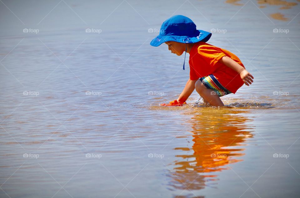 Just a boy and his toy boat 