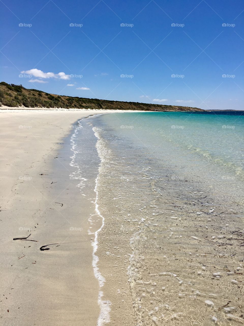 Shoreline pristine remote secluded beach surrounded by rock cliffs in south Australia 