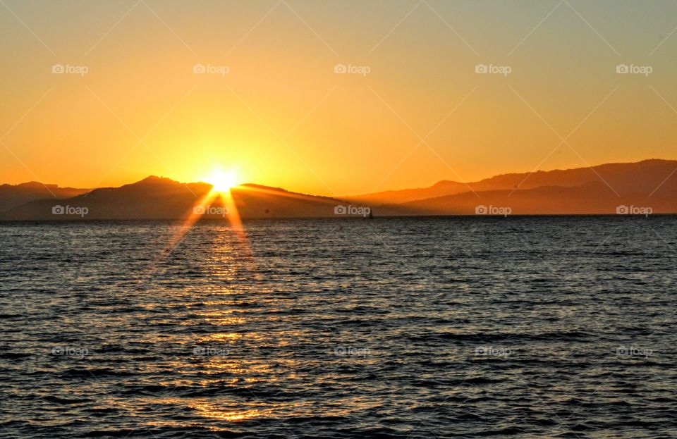 watching the sunset behind the mountains in Emeryville California