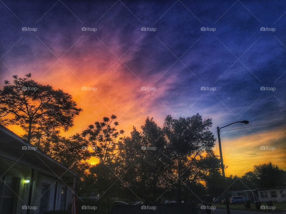 Watching the sunrise reach the moon while painting the sky