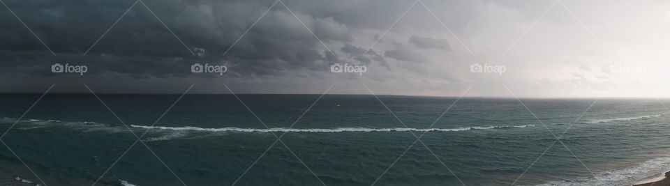 A panorama of a storm moving over a beach in Florida 